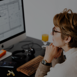 Monitor displaying a brand style guide and website mockup in a creative workspace.